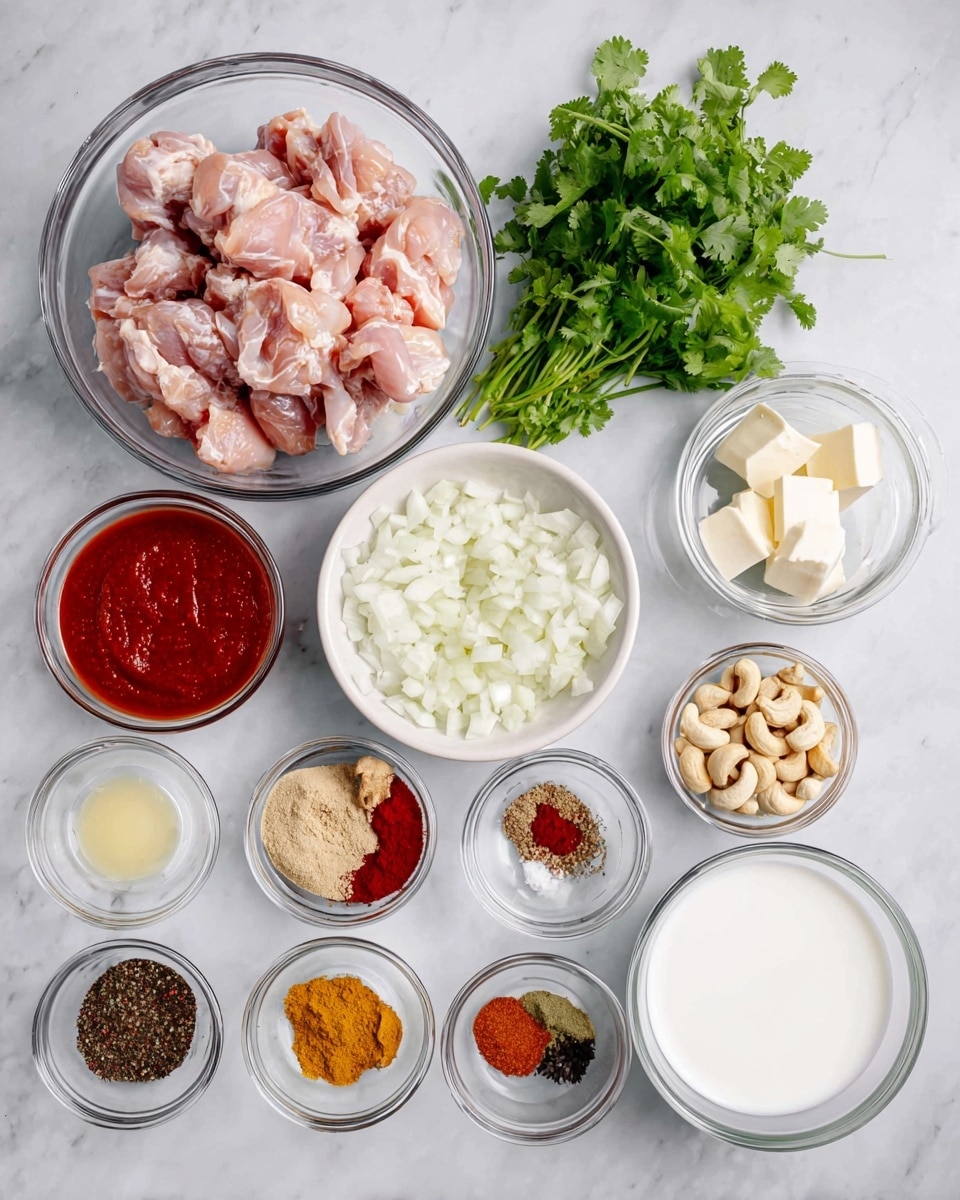 The image shows a white marbled surface with several glass and white bowls containing different ingredients. On the top left is a large glass bowl filled with raw light pink pieces of chicken. To its right is a white bowl with chopped white onions. Next to the onions is a bunch of fresh green cilantro leaves. Below the chicken are small bowls with red tomato sauce, dark red chili powder, yellow curry powder, and brown spices. There are also bowls with white yogurt, chopped ginger and garlic, whole cashew nuts, salt, black pepper, two cubes of butter, a glass bowl of white milk, and a small bowl with clear liquid oil. The ingredients are arranged neatly in rows. photo taken with an iphone --ar 4:5 --v 7
