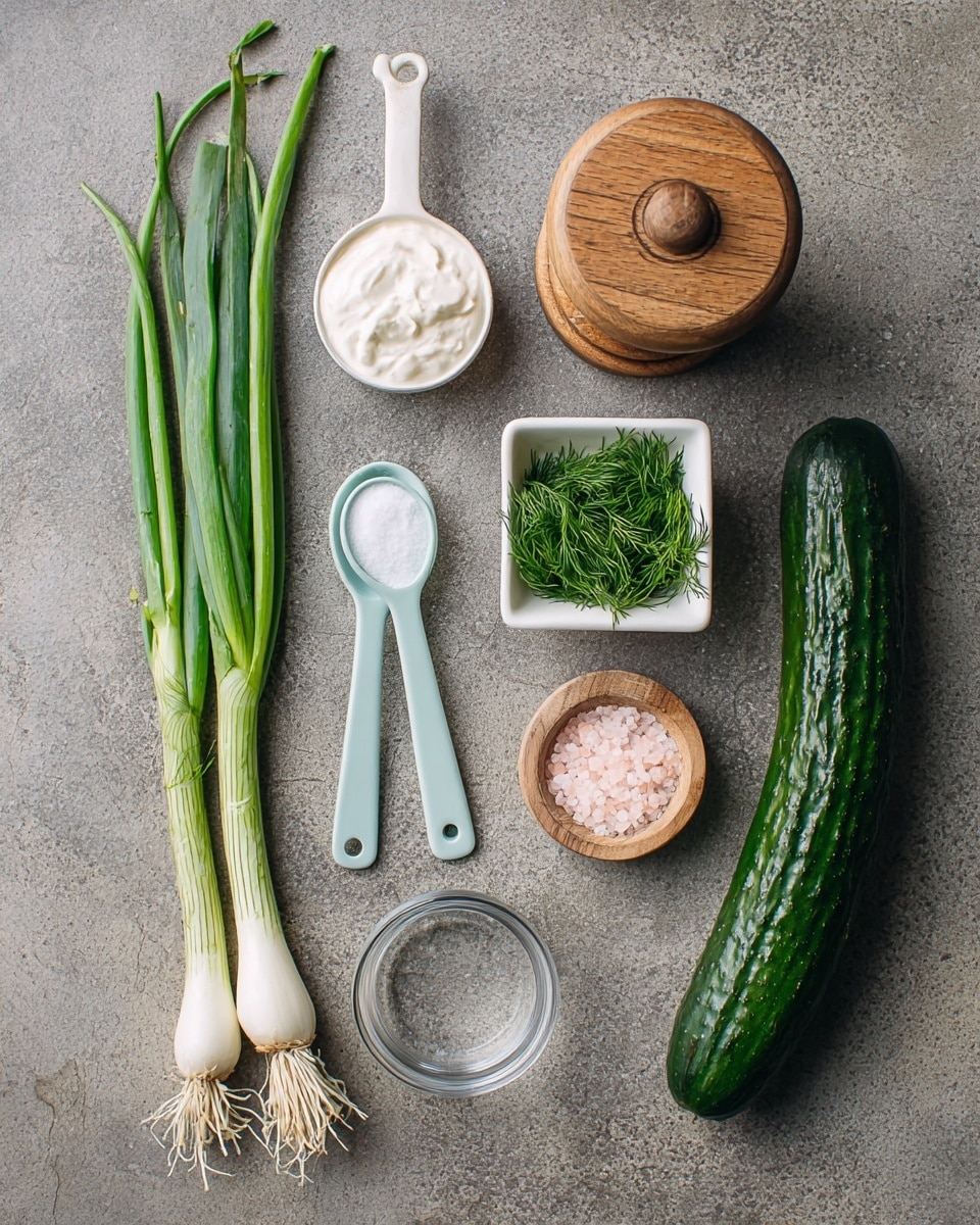 The image shows fresh ingredients arranged on a white marbled surface, including green onions with long green stalks and white bulbs on the left side, a light blue small scoop filled with smooth white cream next to a small square white bowl containing chopped green dill. Above the square bowl is a wooden round container filled with pink salt and a slightly open lid. A wooden pepper grinder rests near a long, dark green cucumber on the right side. There is also a small clear glass bowl and a white measuring spoon with white salt, all placed neatly for preparing a fresh dish. Photo taken with an iphone --ar 4:5 --v 7