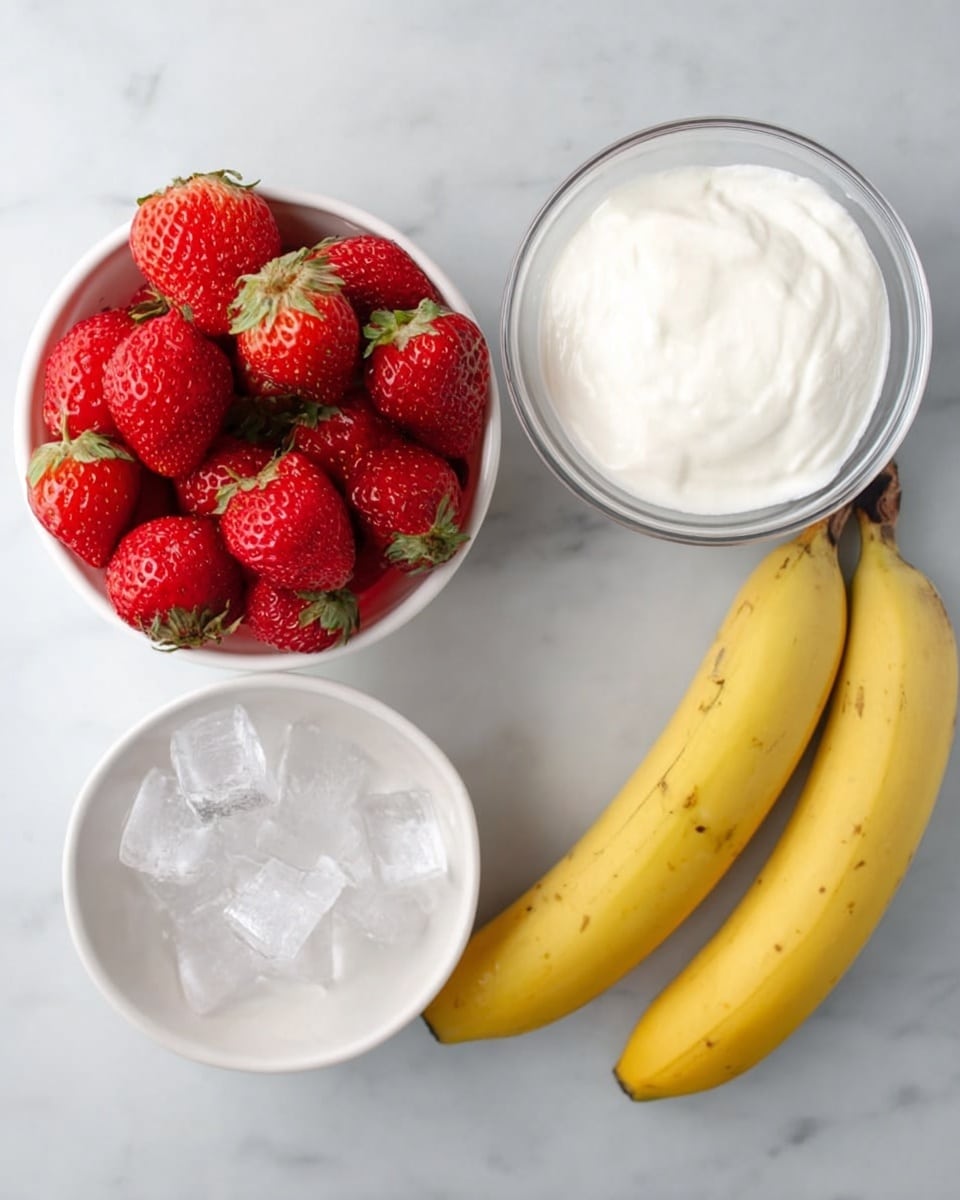 The image shows four white bowls on a white marbled surface. The top left bowl is filled with many red strawberries with green tops. Below it, a smaller white bowl contains clear ice cubes. To the right of this bowl, there is a larger white bowl filled with thick white yogurt. On the right side of the image, two yellow bananas with small brown spots rest directly on the white marbled surface. photo taken with an iphone --ar 4:5 --v 7