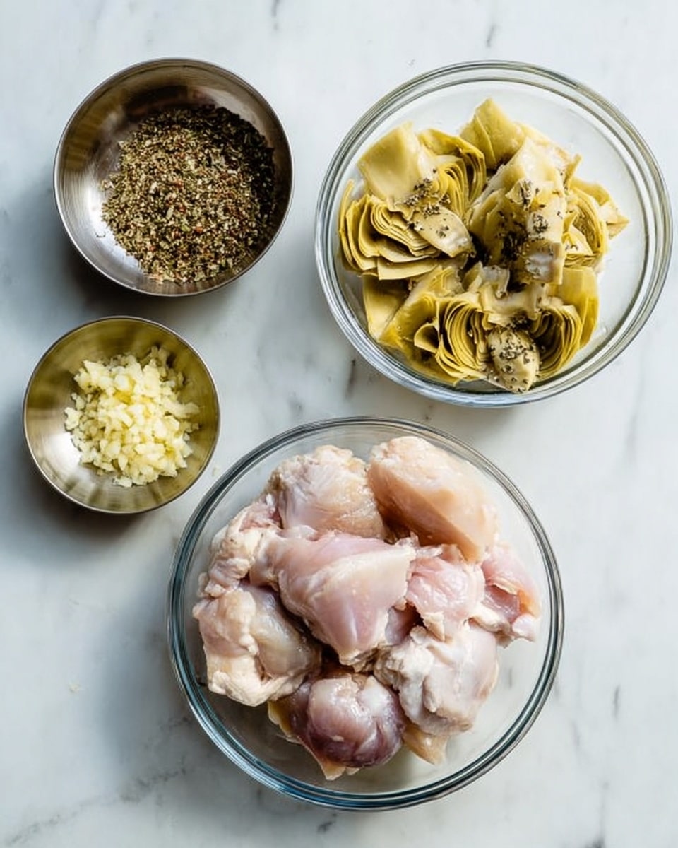 The image shows four bowls arranged on a white marbled surface. The largest bowl at the bottom center is clear glass and filled with raw chicken pieces that are pale pink with some white fat. To the right, a smaller clear glass bowl contains yellowish artichoke hearts with some black seasoning on top. Above the chicken bowl, a small metallic bowl holds a coarse mix of dried herbs, brown and green in color. To the left, another small metallic bowl contains finely minced garlic, pale yellow and slightly chunky. Photo taken with an iphone --ar 4:5 --v 7