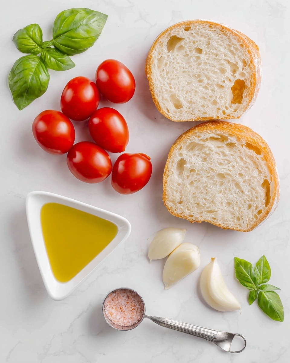 The image shows four small red tomatoes grouped on the left side with shiny, smooth skins, next to two slices of crusty light beige bread with visible air holes on the upper right. Below the bread are three partly peeled garlic cloves with a soft off-white color. Near the center is a small metal measuring spoon filled with pink salt. At the bottom left, there is a white triangular dish filled with golden yellow olive oil. Green basil leaves are placed around the scene, one cluster at the top left and another at the bottom right, all arranged on a white marbled surface. Photo taken with an iphone --ar 4:5 --v 7