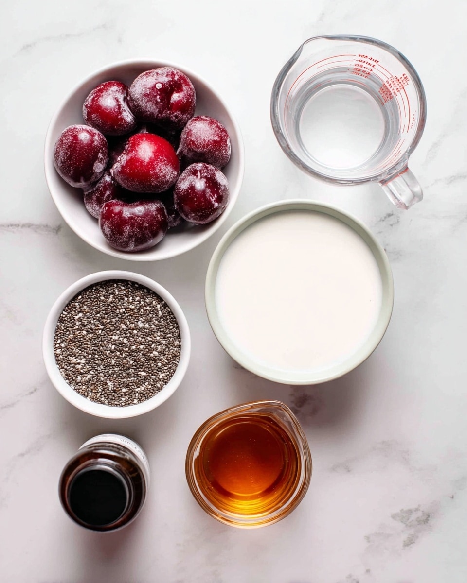 The image shows five containers with ingredients on a white marbled surface. At the top left, there is a white bowl filled with frozen deep red cherries. To the right of it, there is a clear glass measuring cup filled with white milk. Below the cherries, a white bowl holds a layer of small black and white chia seeds covering the base evenly. To the left of the chia seeds is a small dark brown bottle with a black cap, partially visible. On the bottom right, there is a small clear glass pitcher containing amber-colored liquid. All items are brightly lit, with soft shadows. Photo taken with an iphone --ar 4:5 --v 7