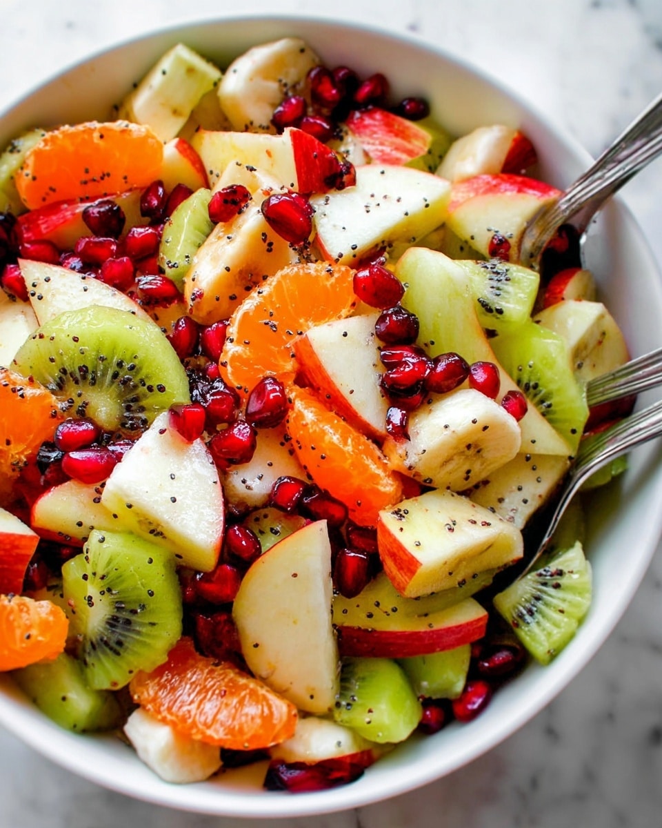 The image shows a close-up view of a colorful fruit salad in a white bowl. The salad has many pieces of different fruits, like green kiwi slices with small black seeds, red and yellow apple chunks with skin, bright orange tangerine segments, creamy white banana slices, and small red pomegranate seeds scattered on top. There are also dark red dried cranberries mixed in and tiny black poppy seeds sprinkled over the fruits. Three metal spoons are placed inside the bowl, ready for serving. The background is a white marbled surface. photo taken with an iphone --ar 4:5 --v 7