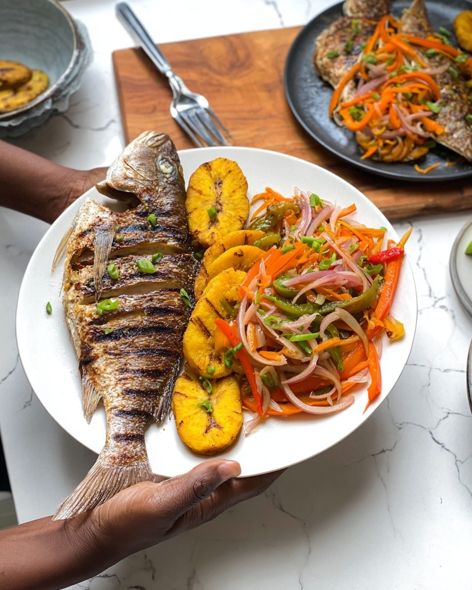 A white plate holds a grilled whole fish with charred marks and slits across its silver-brown skin placed on the left side, with two golden-yellow fried plantain slices beside it. The right side of the plate has a colorful mix of sautéed vegetables, including thin strips of orange carrot, red and green bell peppers, and translucent onion slices, garnished with small green onion pieces on top. A woman's hand is holding the plate from the right side. In the background on a white marbled surface, there is another plate with a similar fish topped with vegetables and a small pile of fried plantains on a dark plate. A bowl with a fork on a wooden board is also visible. Photo taken with an iphone --ar 4:5 --v 7