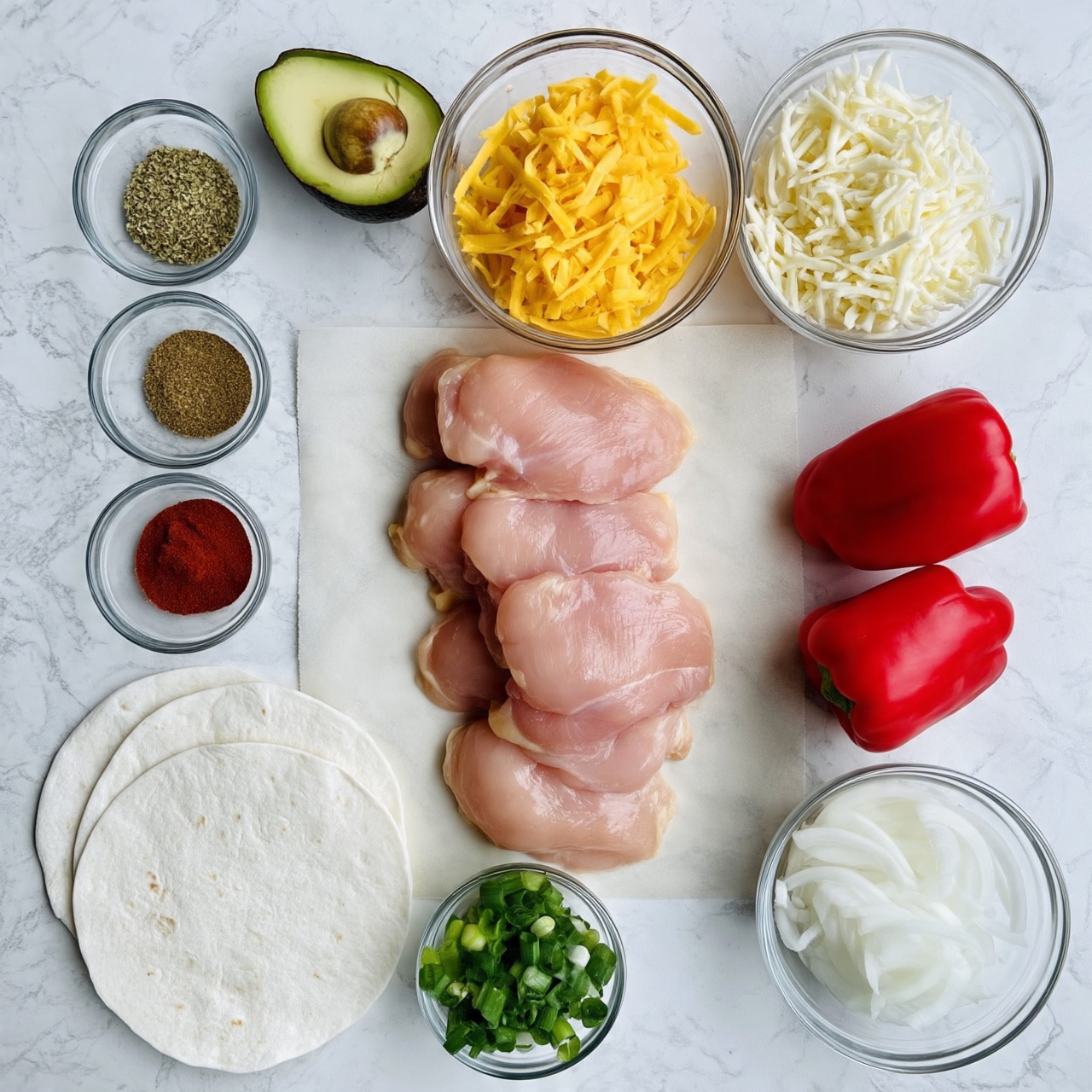 The image shows fresh ingredients neatly placed on a white marbled surface. At the center, there are several raw, pale pink chicken thighs stacked on a piece of parchment paper. To the top right, two clear glass bowls hold shredded yellow cheddar cheese and shredded white cheese, side by side. Below, two bright red bell peppers sit close to each other. On the left, three soft white tortillas overlap in a semi-circle. To the far left, there are three small glass bowls containing dried oregano, brown spice powder, and red chili powder, arranged vertically. Near the bottom right corner, a clear bowl holds sliced white onions, and next to it, a smaller bowl contains chopped green scallions. At the top left, a ripe avocado is halved with the seed visible in one half. photo taken with an iphone --ar 4:5 --v 7